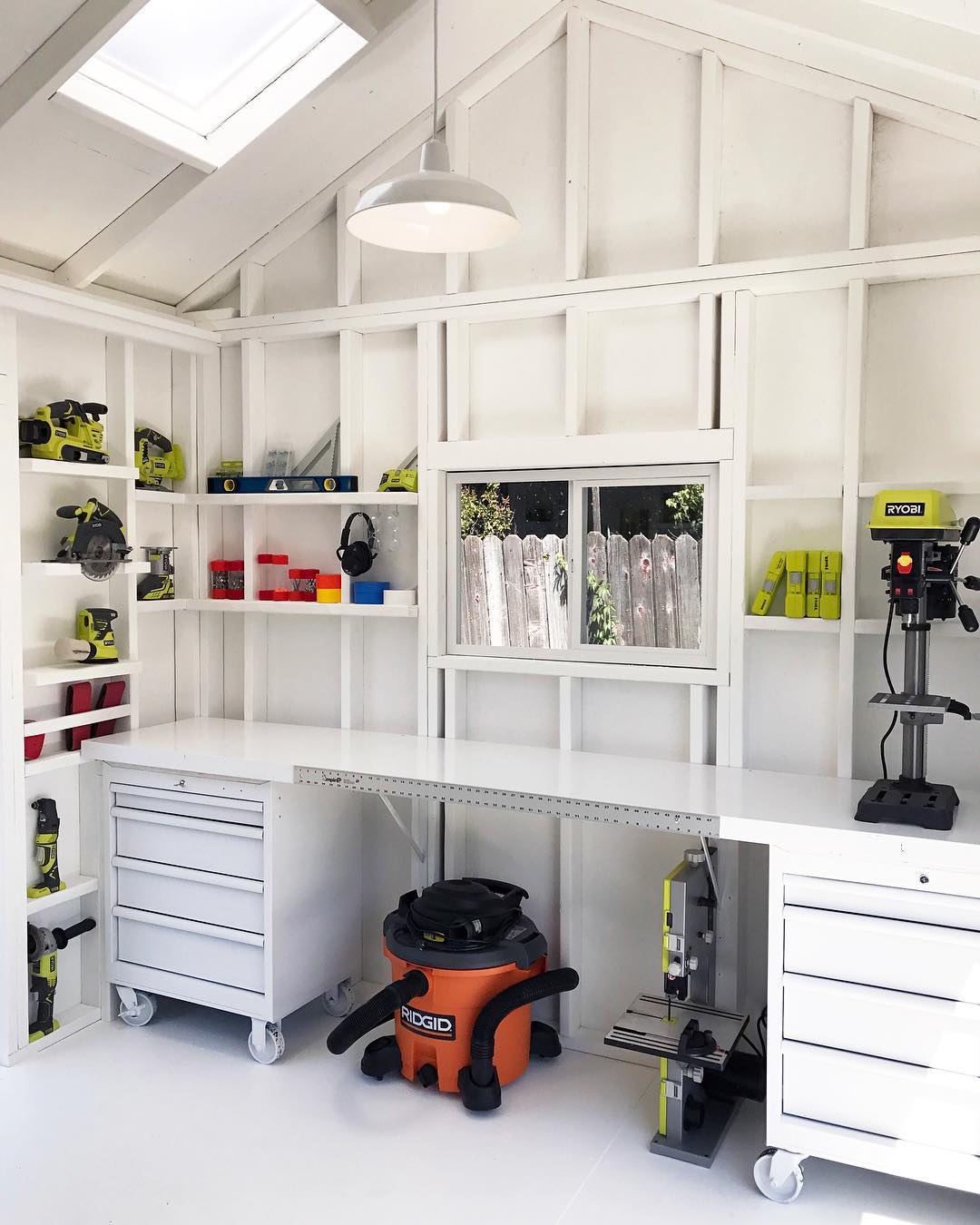 white workbench in shed with rolling storage tool chests photo by Instagram user @tuffshed