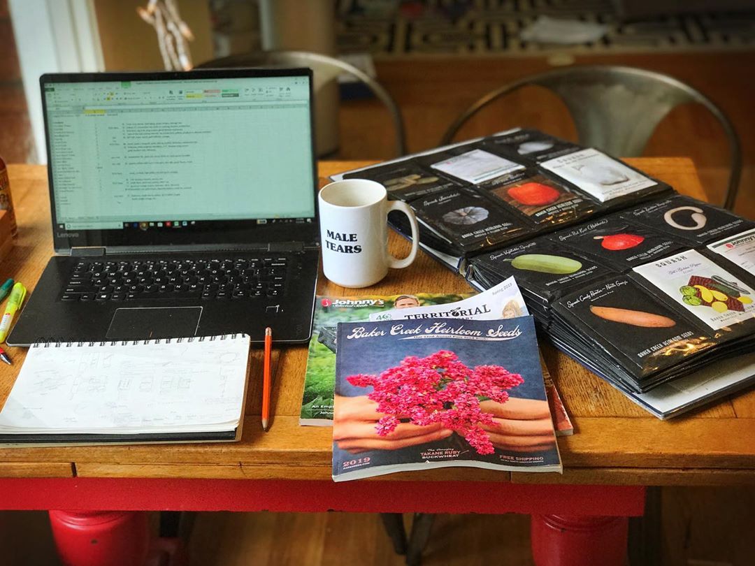 work station organizing vegetable seeds in photo album photo by Instagram user @organicallygrowing