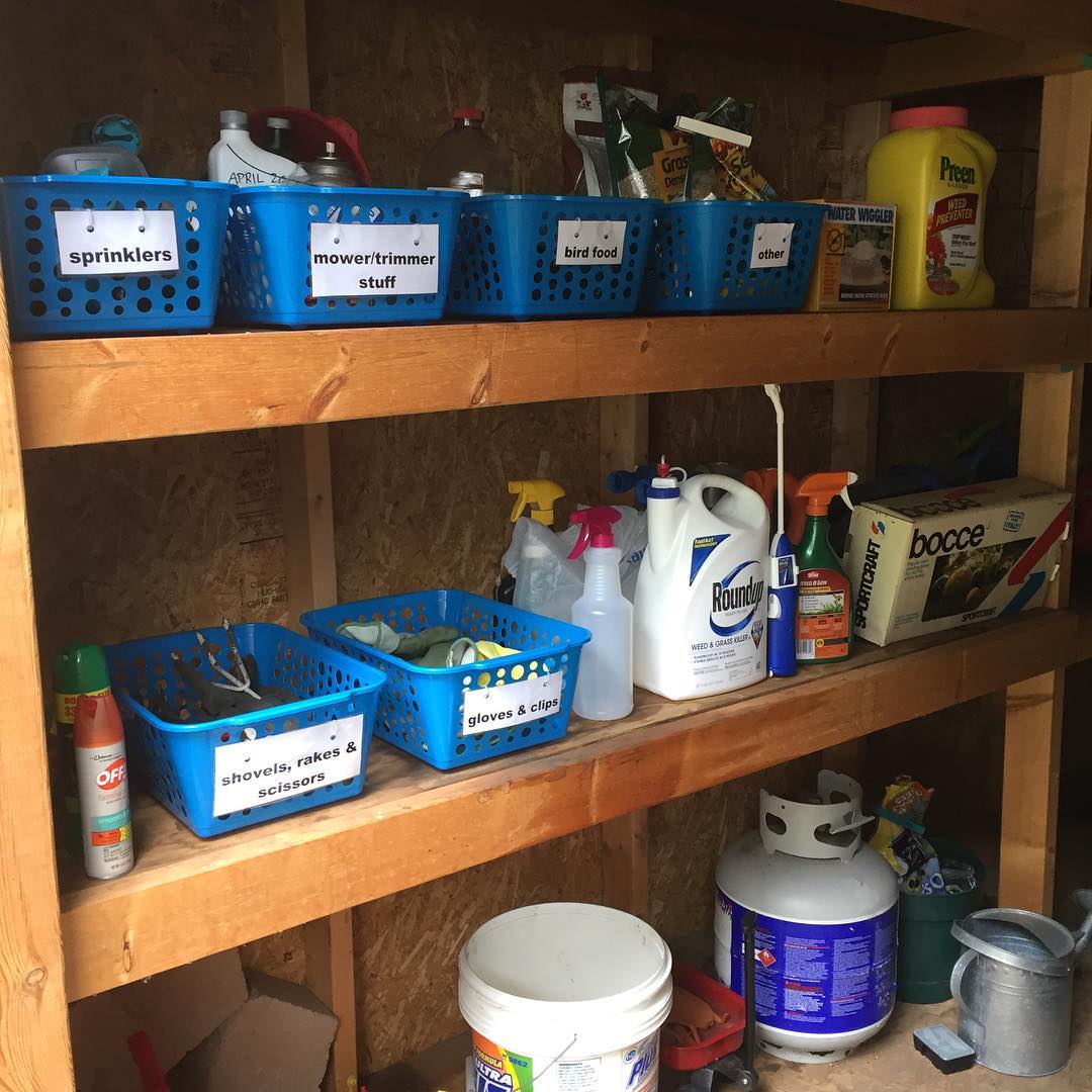 plastic storage bins holding garden tools on shelves photo by Instagram user @justbethmn