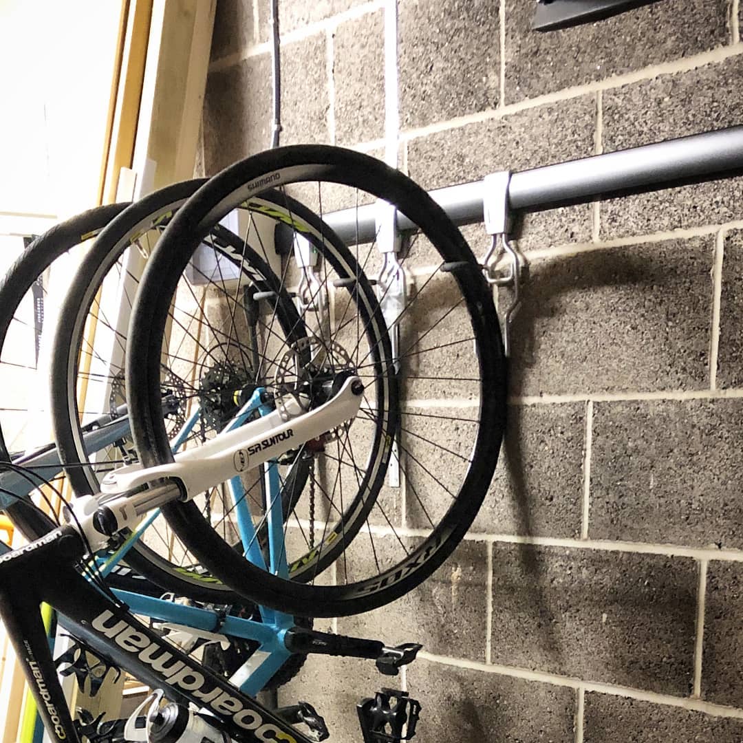 bikes being hung on strong hooks in shed photo by Instagram user @thebikehanger