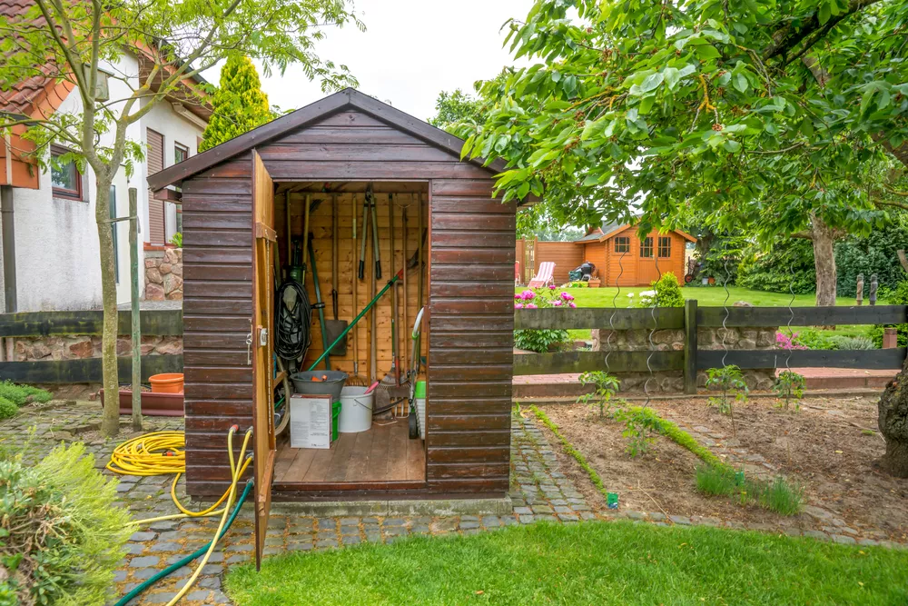 Outdoor shed with lawn and garden tools inside