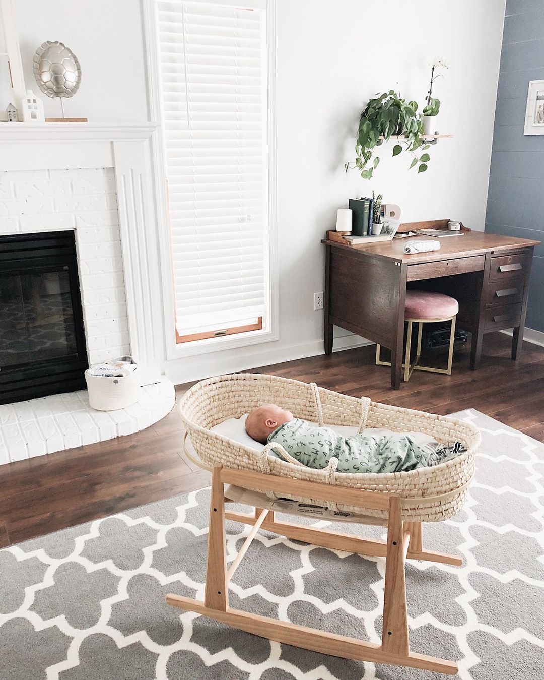 Baby sleeping in bassinet in living room. Photo by Instagram user @hellosparrows