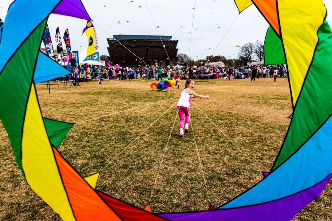 Child flying a kite at Cherry Blossom Festival in Washington DC. Photo via Instagram user @cherryblossfest