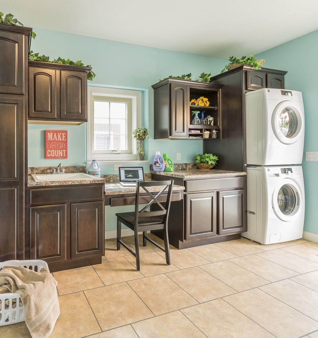 combination room with built in desk and laundry room photo by Instagram user @rochester_homes_inc