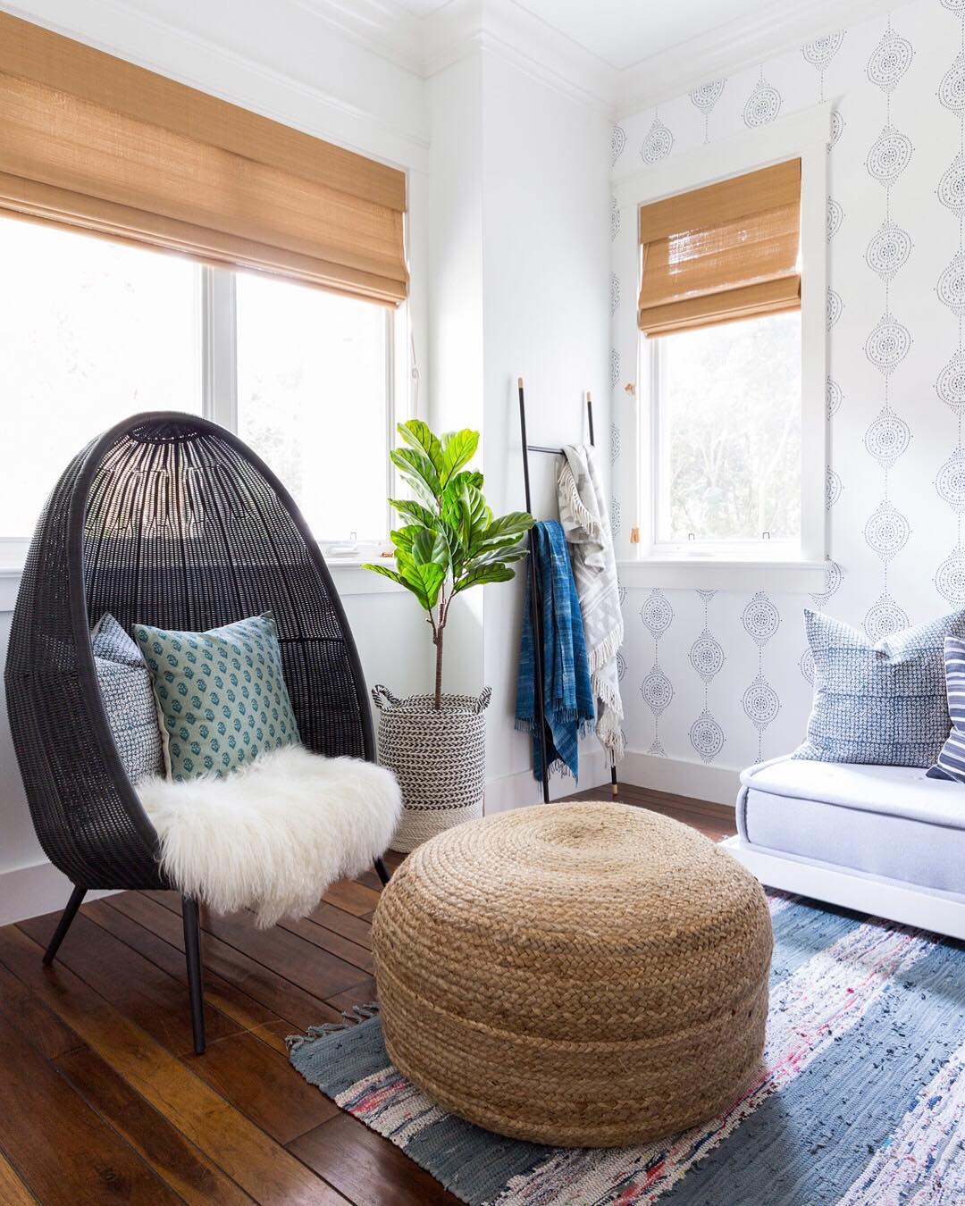 small hangout room with egg shaped chair and small ottoman with lots of natural light photo by Instagram user @lindseybrookedesign