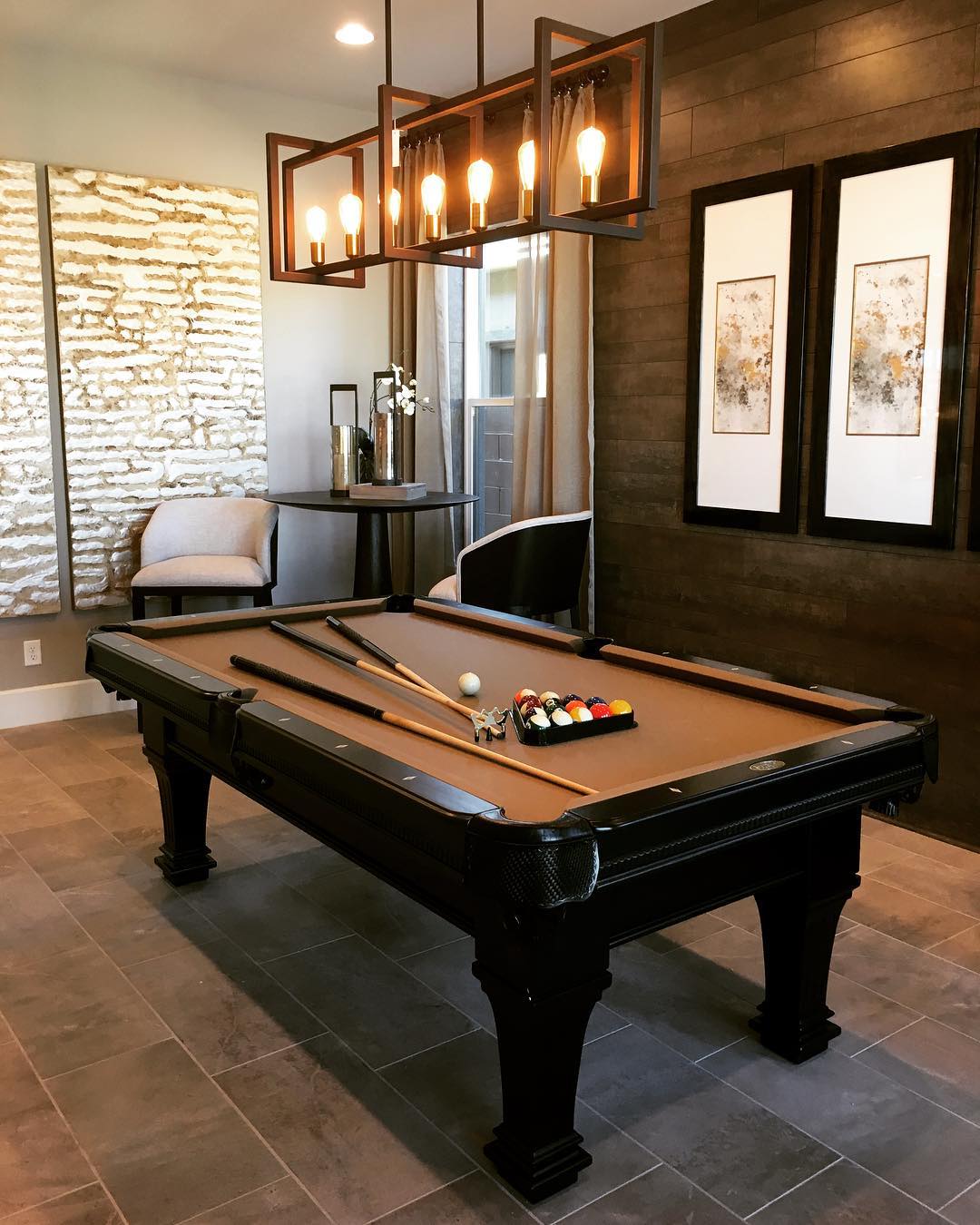 small entertainment room with dark pool table in the middle photo by Instagram user @searchviewvegas