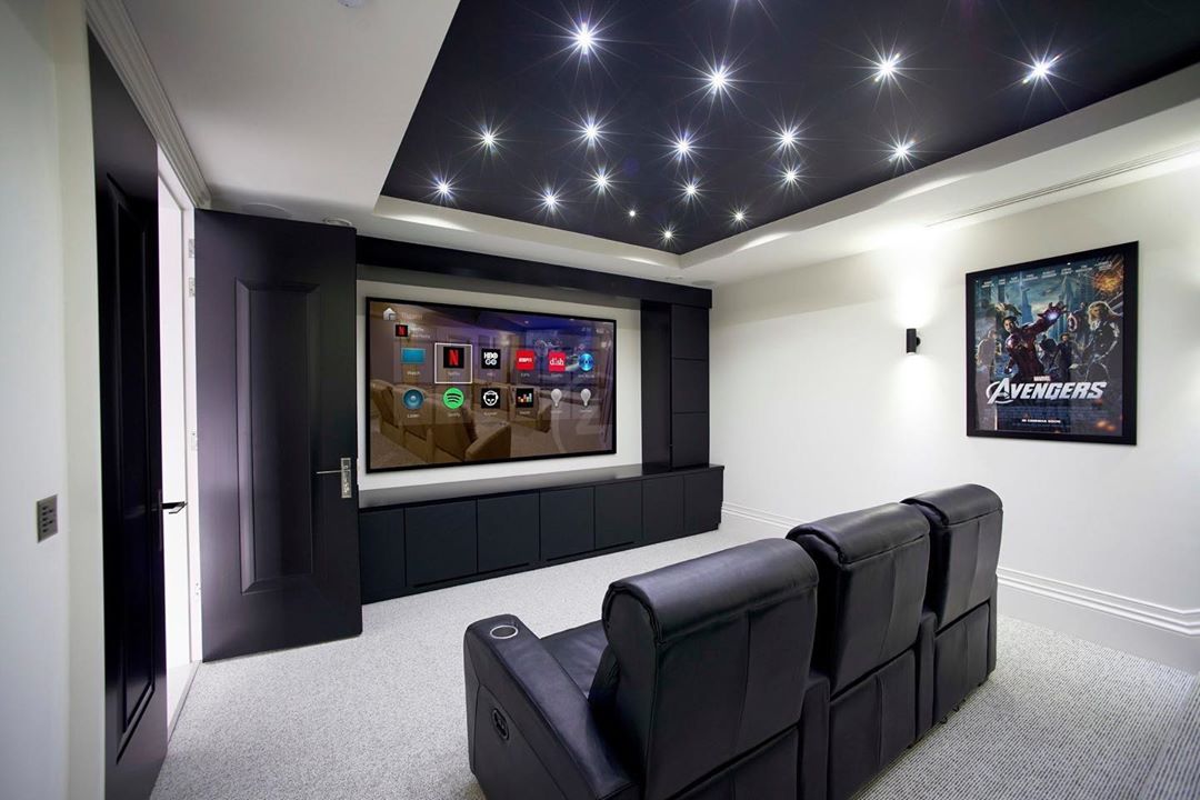 home theater with limited seating and large tv on the wall photo by Instagram user @rndtechnology