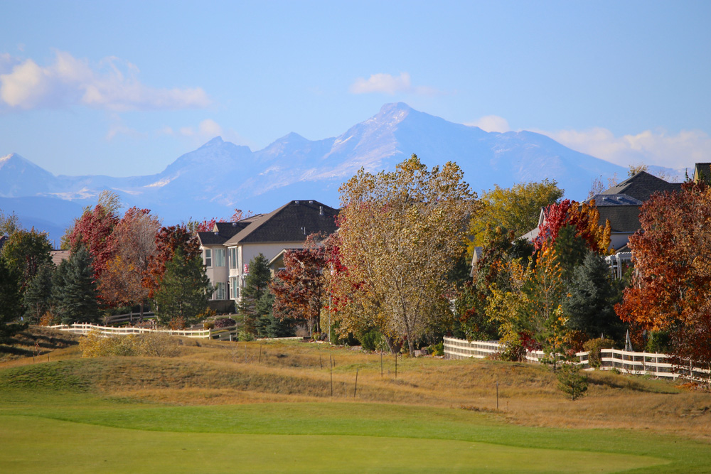 Denver neighborhood next to golf course with mountains in the background