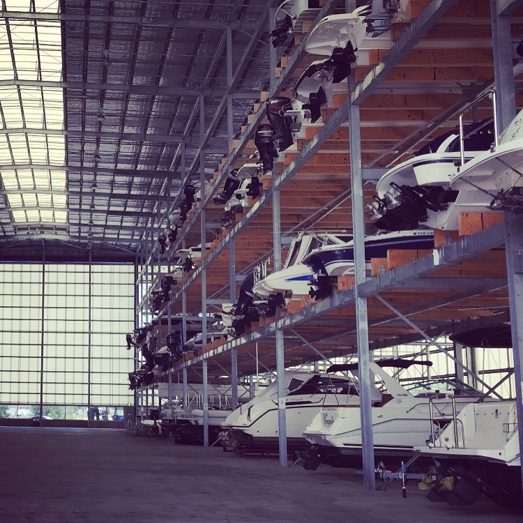 boats stacked inside of a dry storage hangar photo by Instagram user @sydneyboathouse