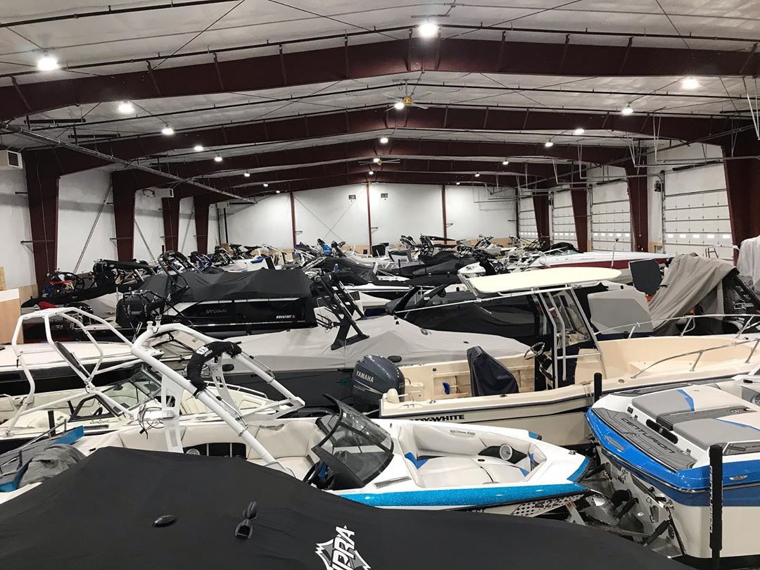 multiple boats being stored inside of a self storage facility photo by Instagram user @toygaragellc