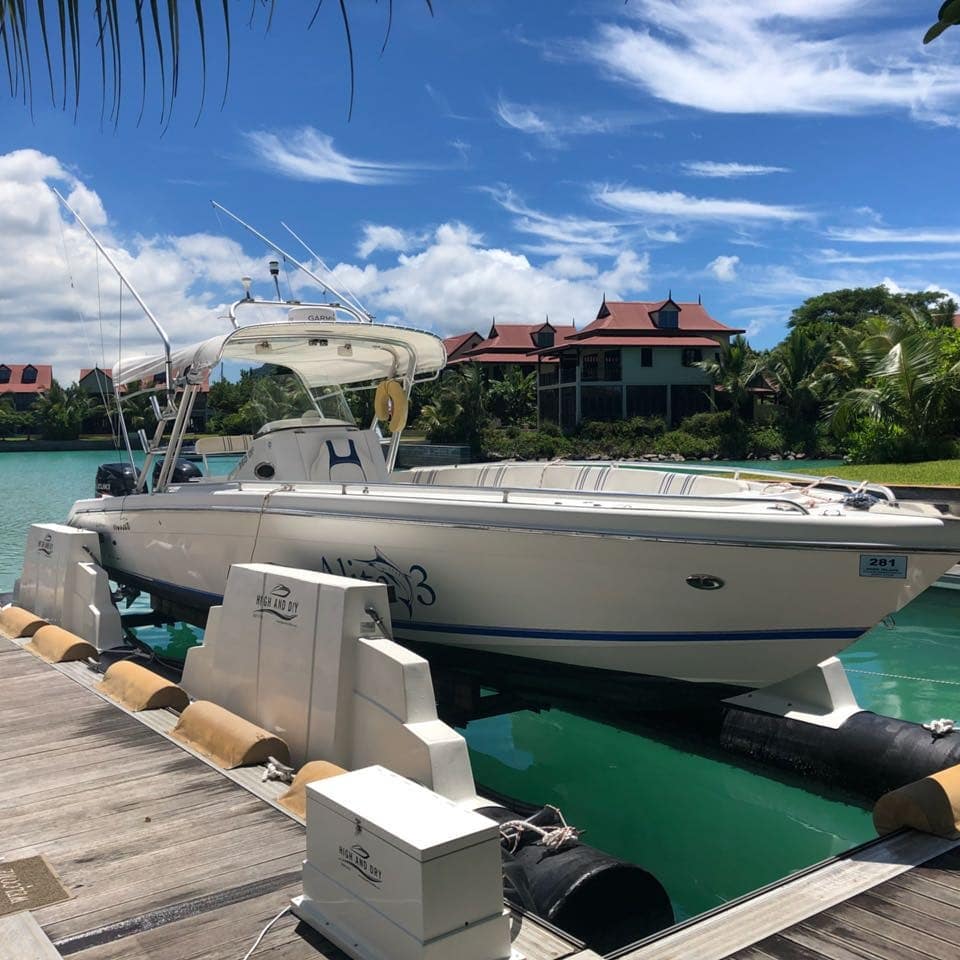 large bow rider boat stored on a home lift photo by Instagram user @highanddryboatlifts