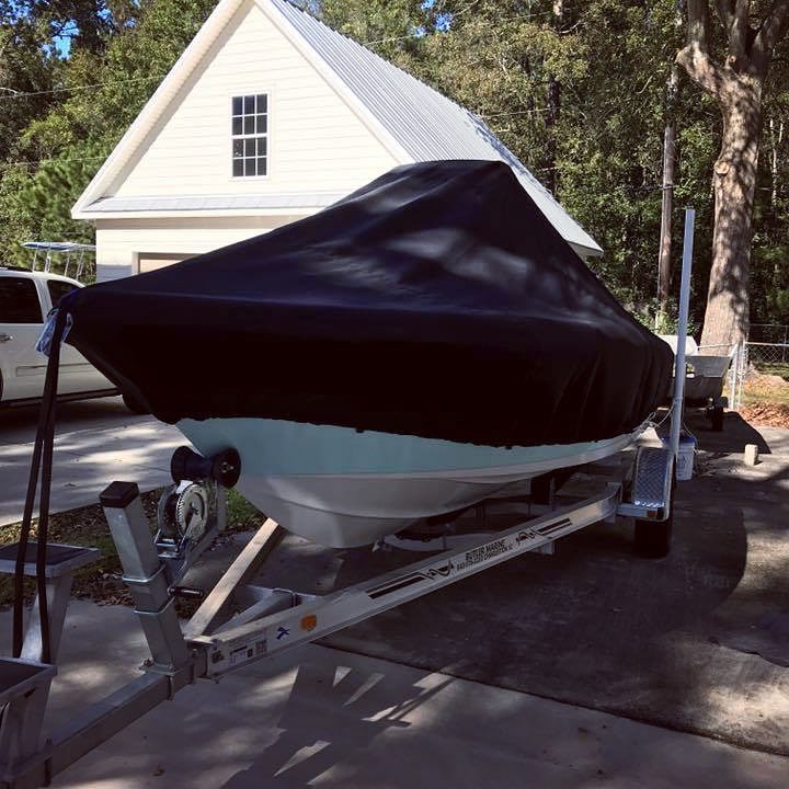 boat with a black cover sitting atop a trailer at a home photo by Instagram user @laporteproducts