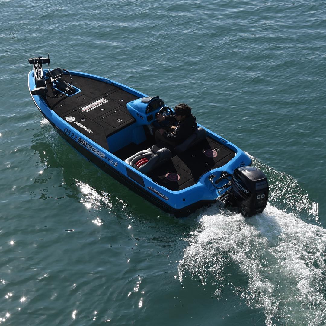 blue bass boat with black lining and one driver photo by Instagram user @southerboats