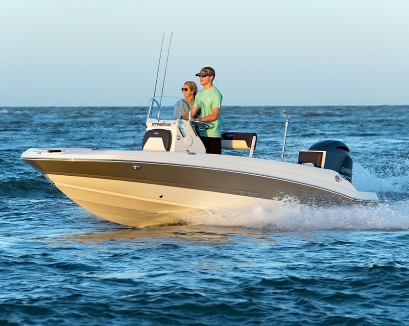 younger people standing and driving a center console boat on water photo by Instagram user @stingrayboats