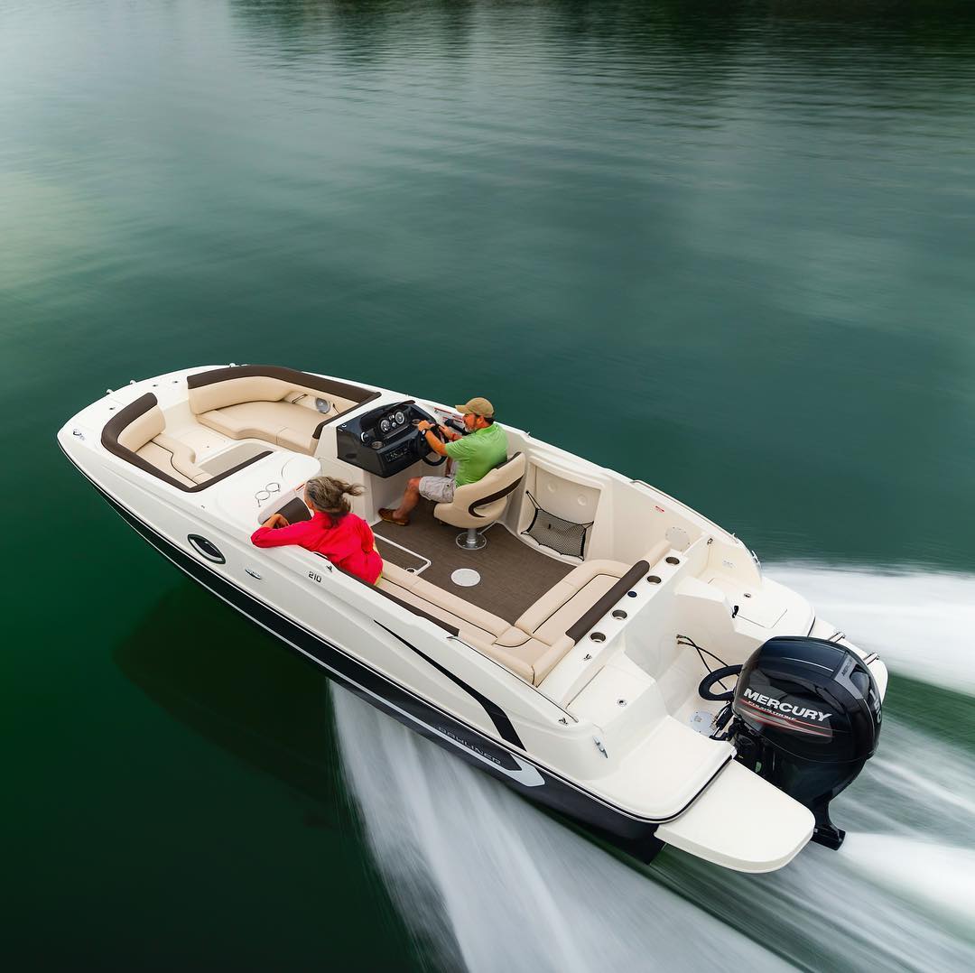 two people riding in a white and brown deck boat on blueish green water photo by Instagram user @baylinerboats