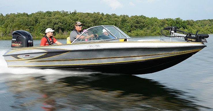 fish and ski boat with four passengers gliding in the water photo by Instagram user @triton_boats_official