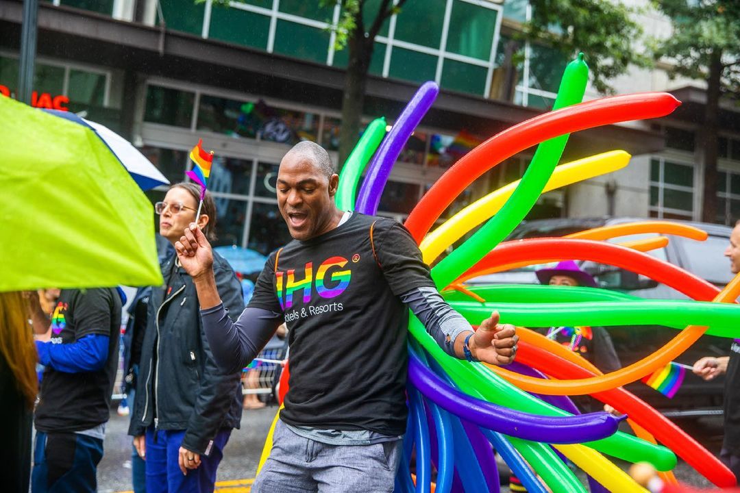 People celebrating in a pride parade. Photo by @ktcooperphoto