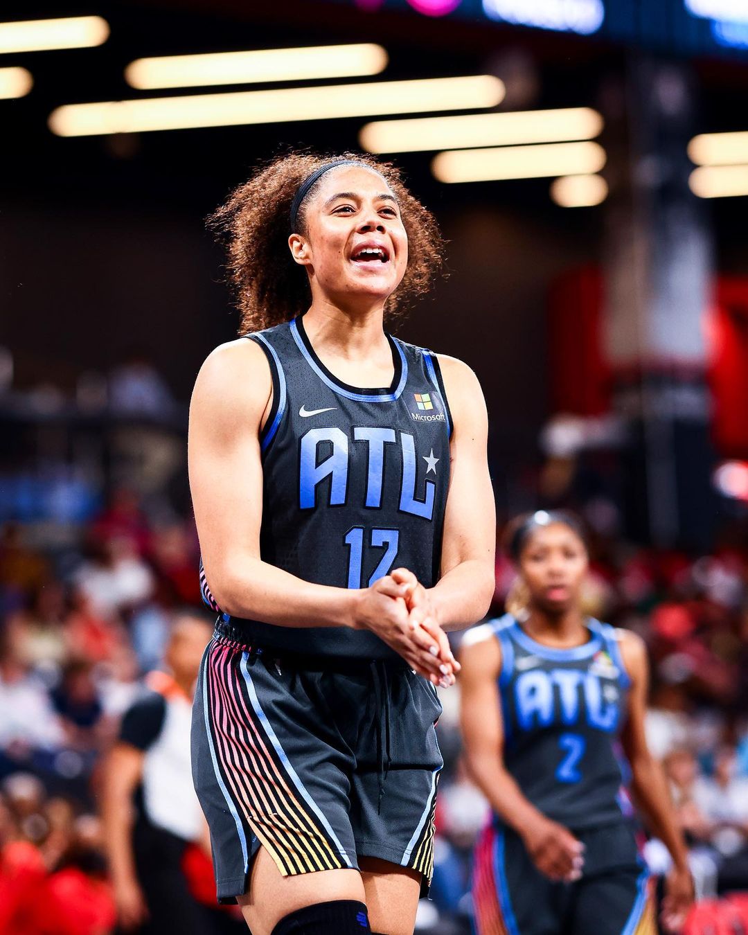 Atlanta Dream player cheering on the basketball court. Photo by Instagram user @atlantadream