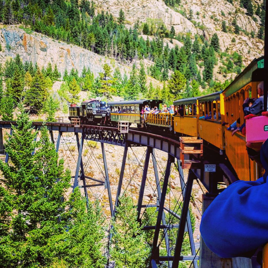 Passenger Train Moving Along Elevated Tracks Through the Rocky Mountains. Photo by Instagram user @xmolinavalos