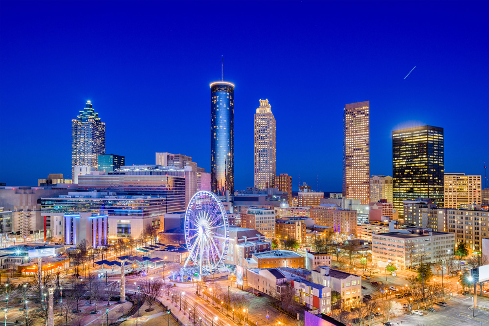 aerial shot of downtown Atlanta Ga at nighttime with a ferris wheel and tall buildings