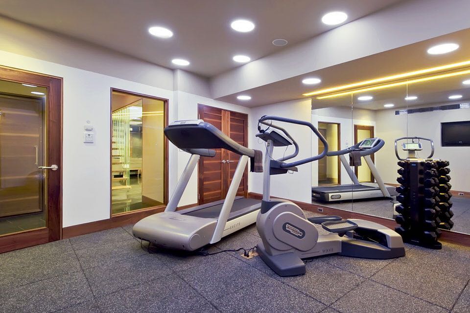 Basement with fitness equipment and rubber flooring. Photo by Instagram user @christinetuttledesign