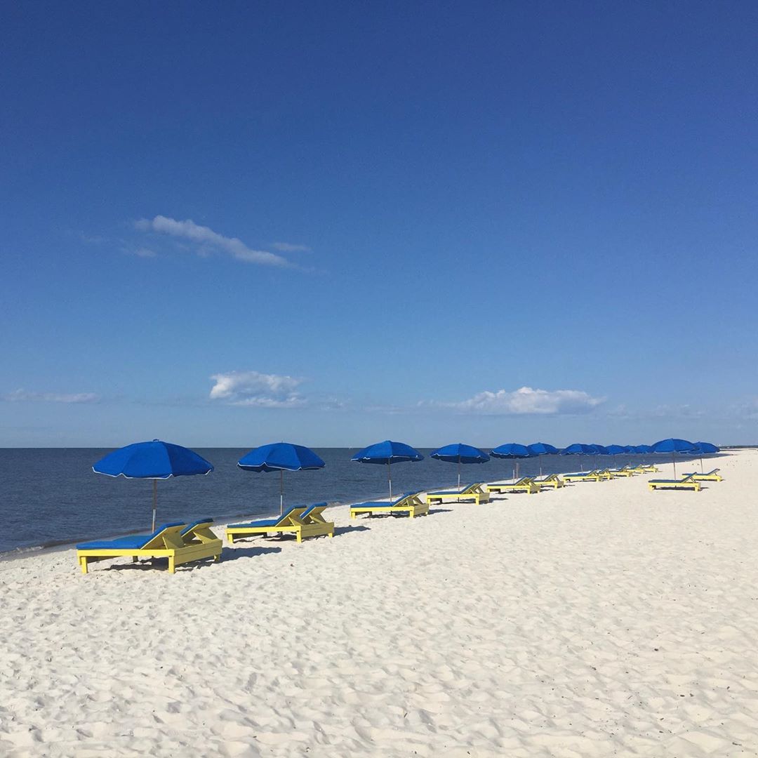 Mini Cabanas Set Up on a White Sand Beach at Biloxi Beach in Mississipi. Photo by Instagram user @gulfcoastbnb