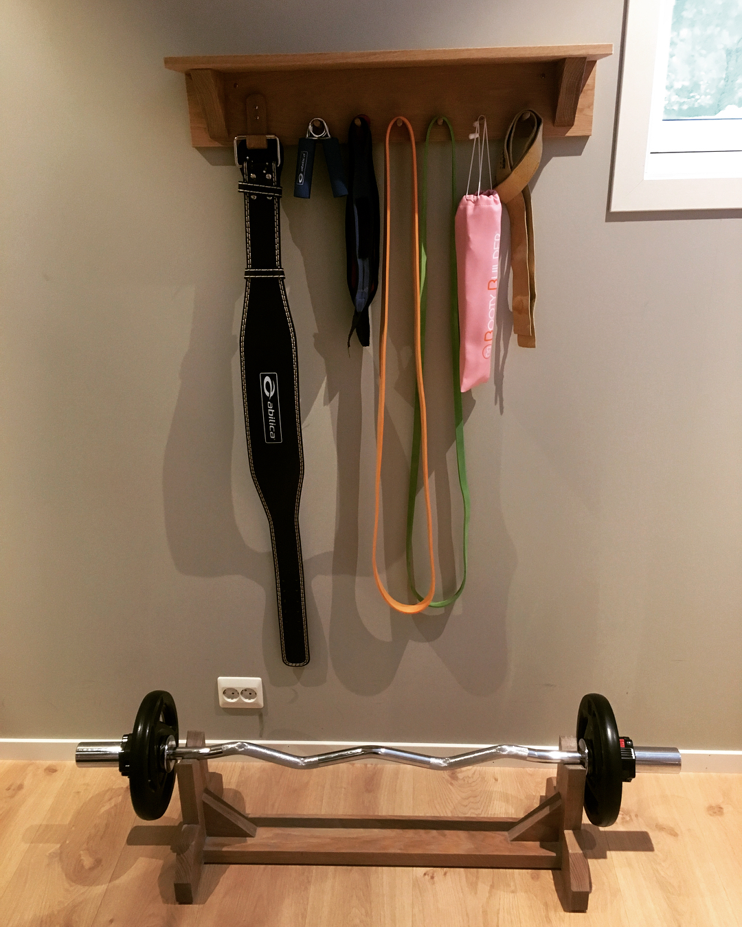 Coat rack with weight belts, resistance bands in home fitness room. Photo by Instagram user @frodet_