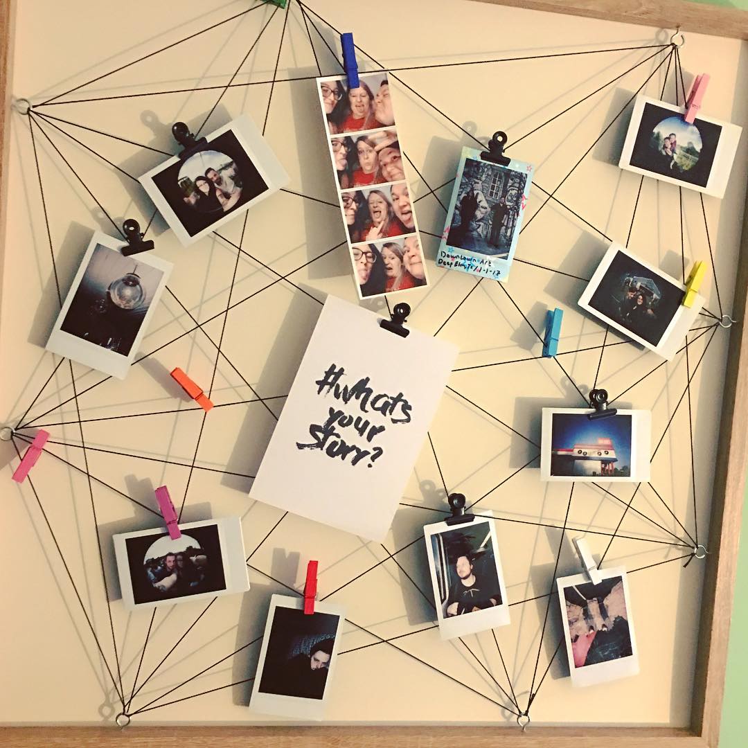 photos hung up on the wall using clothespins and string photo by Instagram user @chrissyboxful