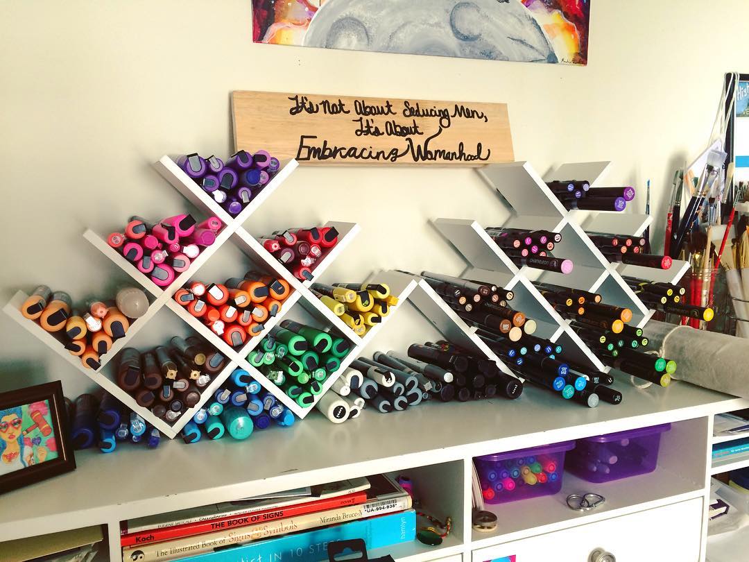 old wine racks used for art supply storage photo by Instagram user @ariesartnw