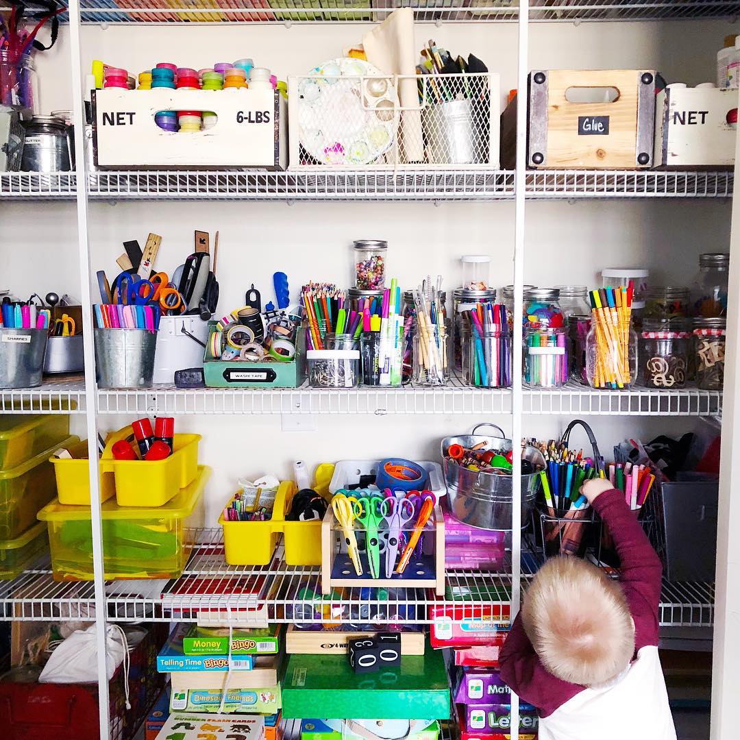 wire shelves in a closet set up for craft supplies photo by Instagram user @collinsschoolhouse