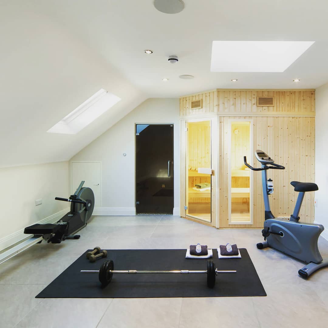 Home fitness center and sauna built into an attic space. Photo by Instagram user @valleycustomhomes