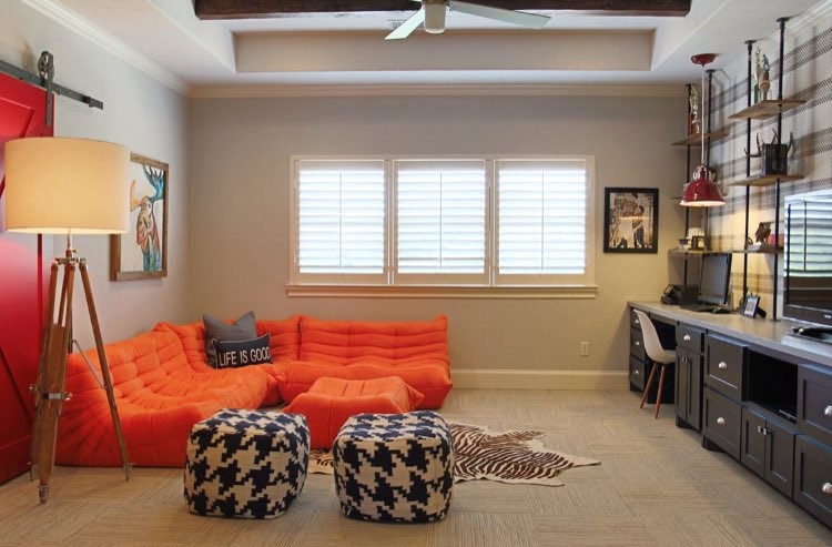 Kids game room with soft orange couches. Photo by Instagram user @angelineguidodesign