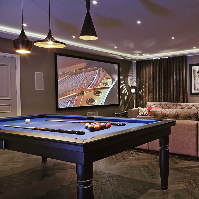 Navy blue pool table in game room. Photo by Instagram user @luxurypooltables