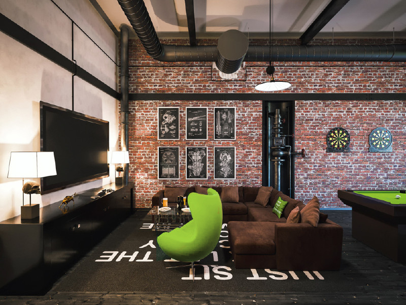 Industrial style game room with brick walls and modern furniture.