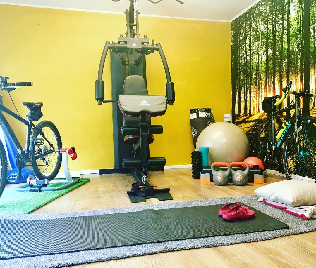 Home fitness room with bright yellow accent wall. Photo by Instagram user @thisgirlcanambassador