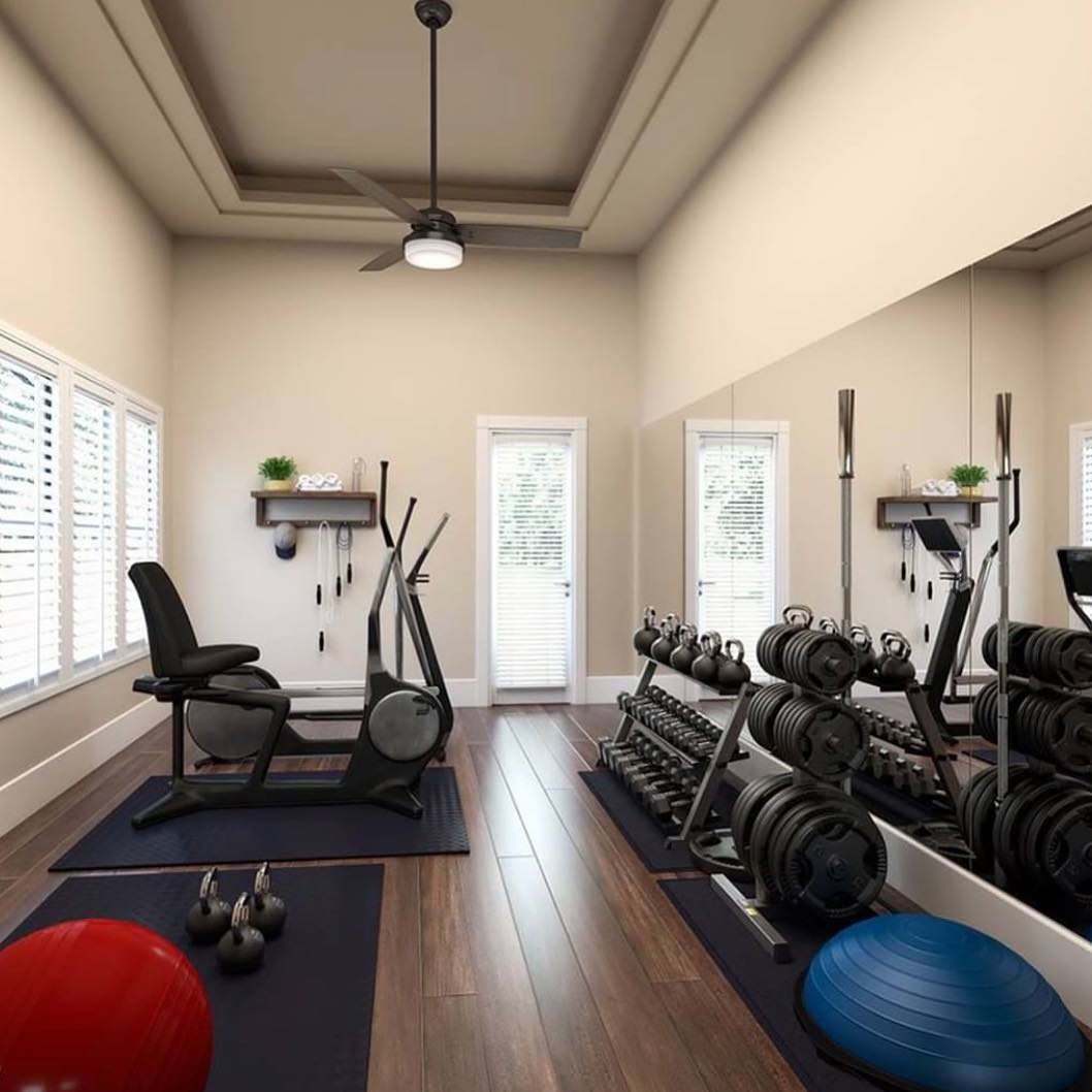 Home fitness room with bike, weights, and ceiling fan. Photo by Instagram user @queen2bee68.