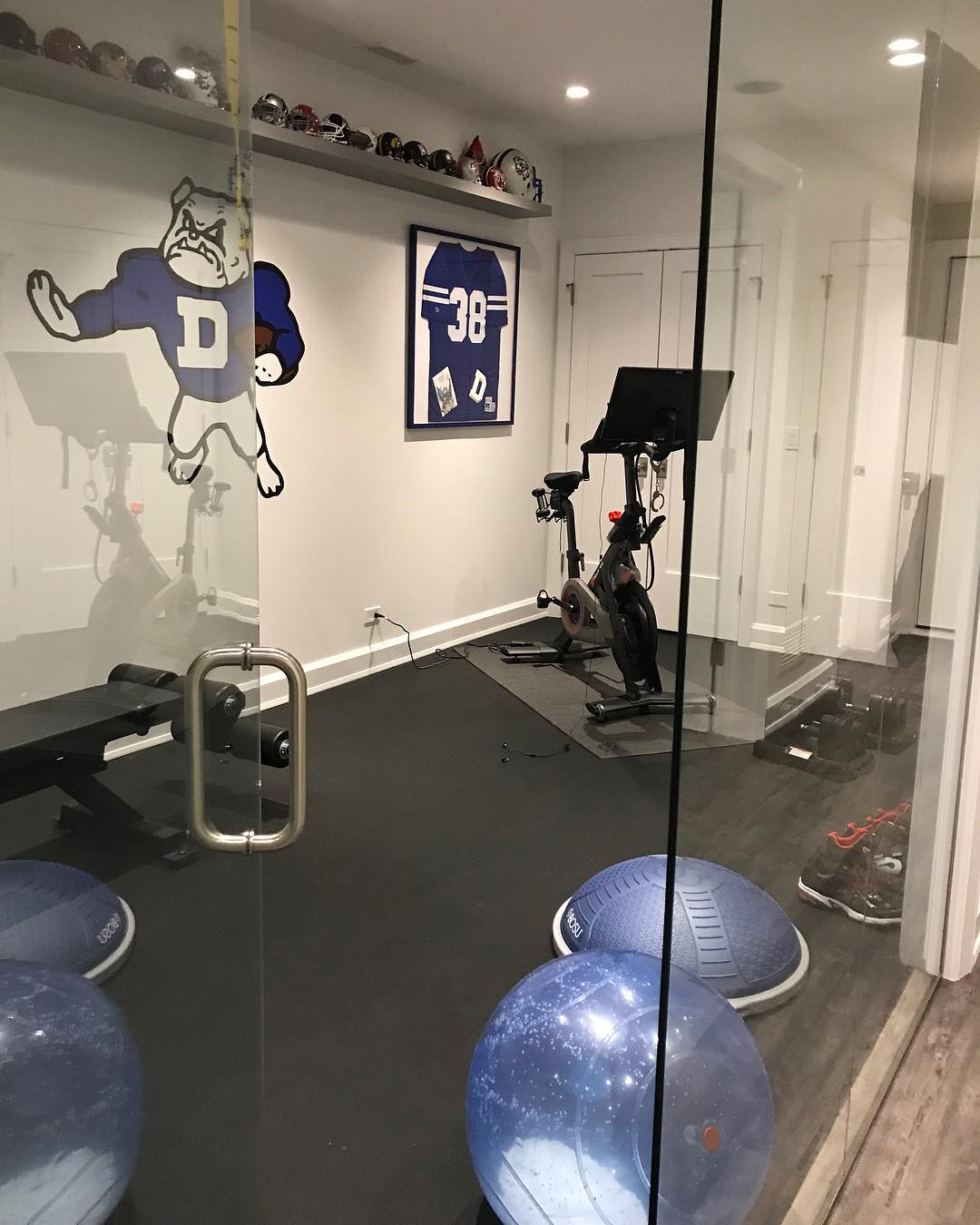 Fitness room in home decked out with Drake University wall decor. Photo by Instagram user @jamieschachteldesign
