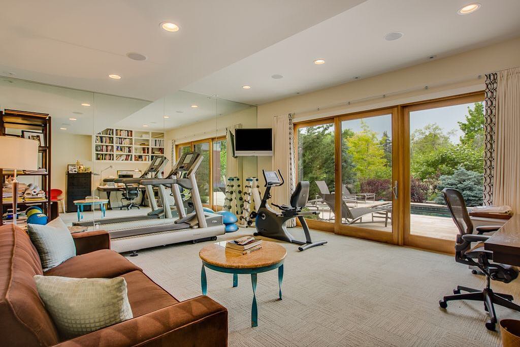 Home office with stationary bike and treadmills. Photo by Instagram user @chanindevelopment