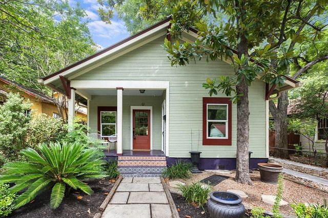 green bungalow with and mosaic tile steps. photo via Instagram user @kenneygrantrealty