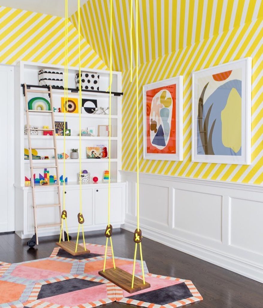 Yellow swings hanging from ceiling in yellow striped room. Photo by Instagram user @interiorjoy