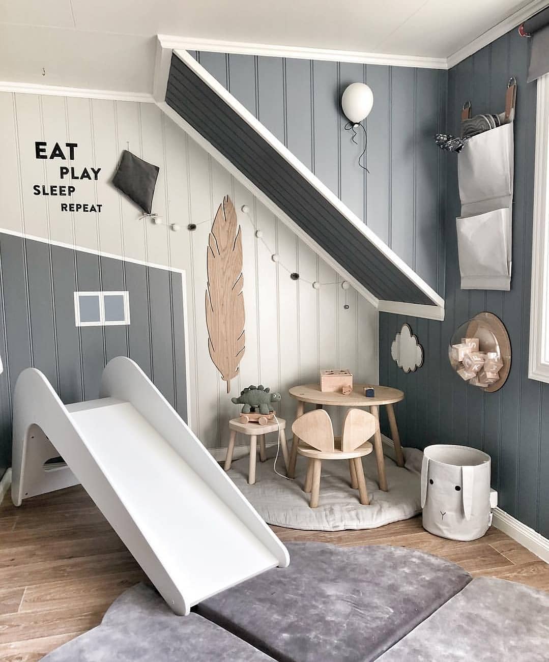 Grey kids room with fuzzy rug and white slide. Photo by Instagram user @jupiduu_original