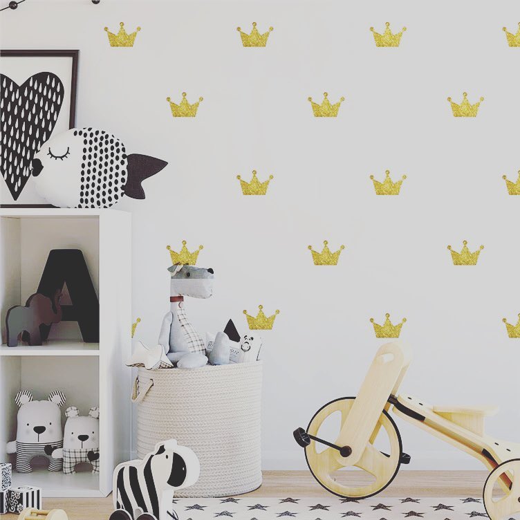 Yellow crown decals on white wall in kids room. Photo by Instagram user @superwallart