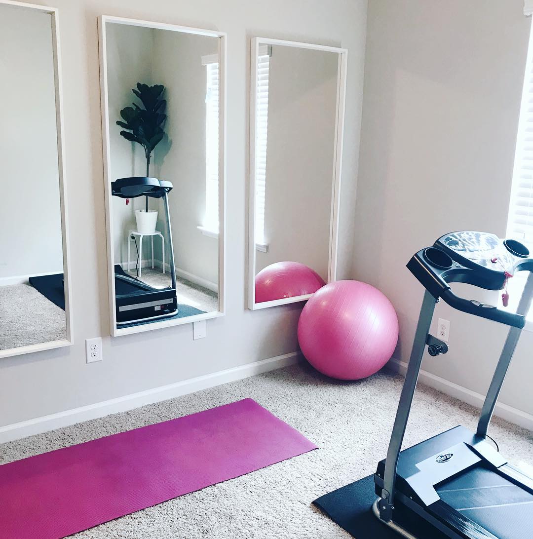 Three mirrors on wall in home fitness room. Photo by Instagram user @cara_lanelle