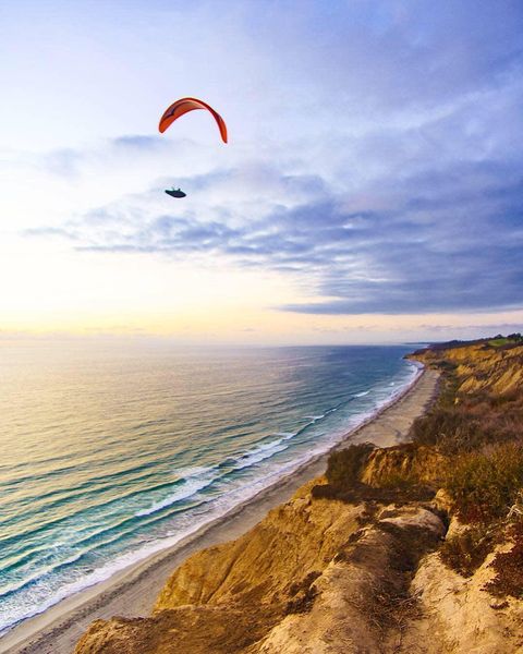 picture with paraglider above ocean photo via @visitsandiego