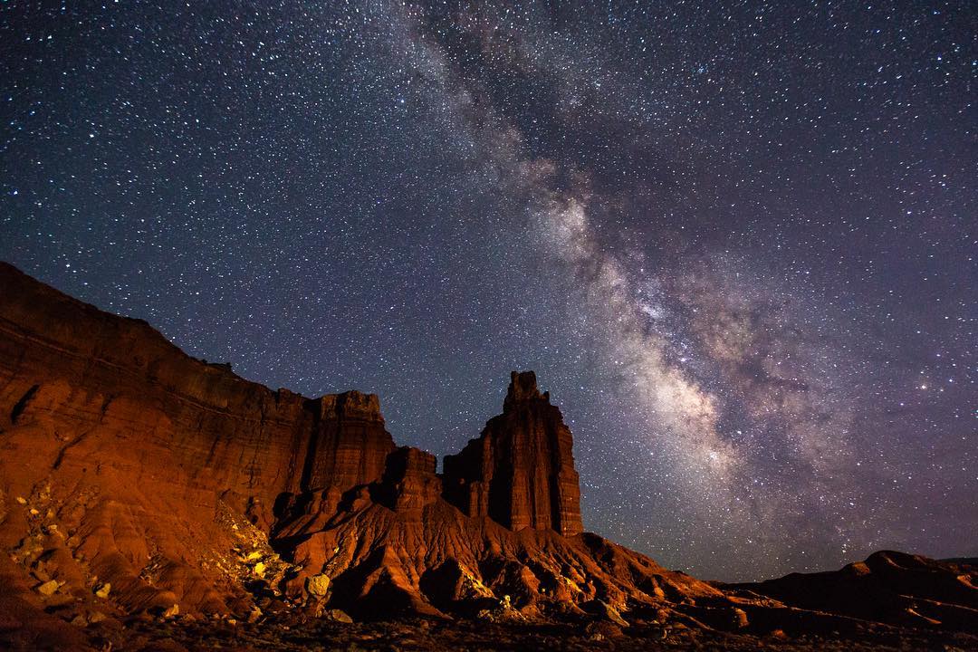 Capitol Reef National Park sits under a dark stary sky. Photo by Instagram user @capitolreefnps