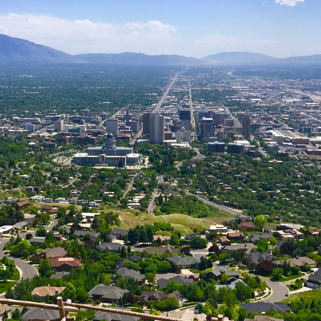 Aerial view of downtown Salt Lake City with mountains in the distance. Photo by Instagram user @real_estate_jace