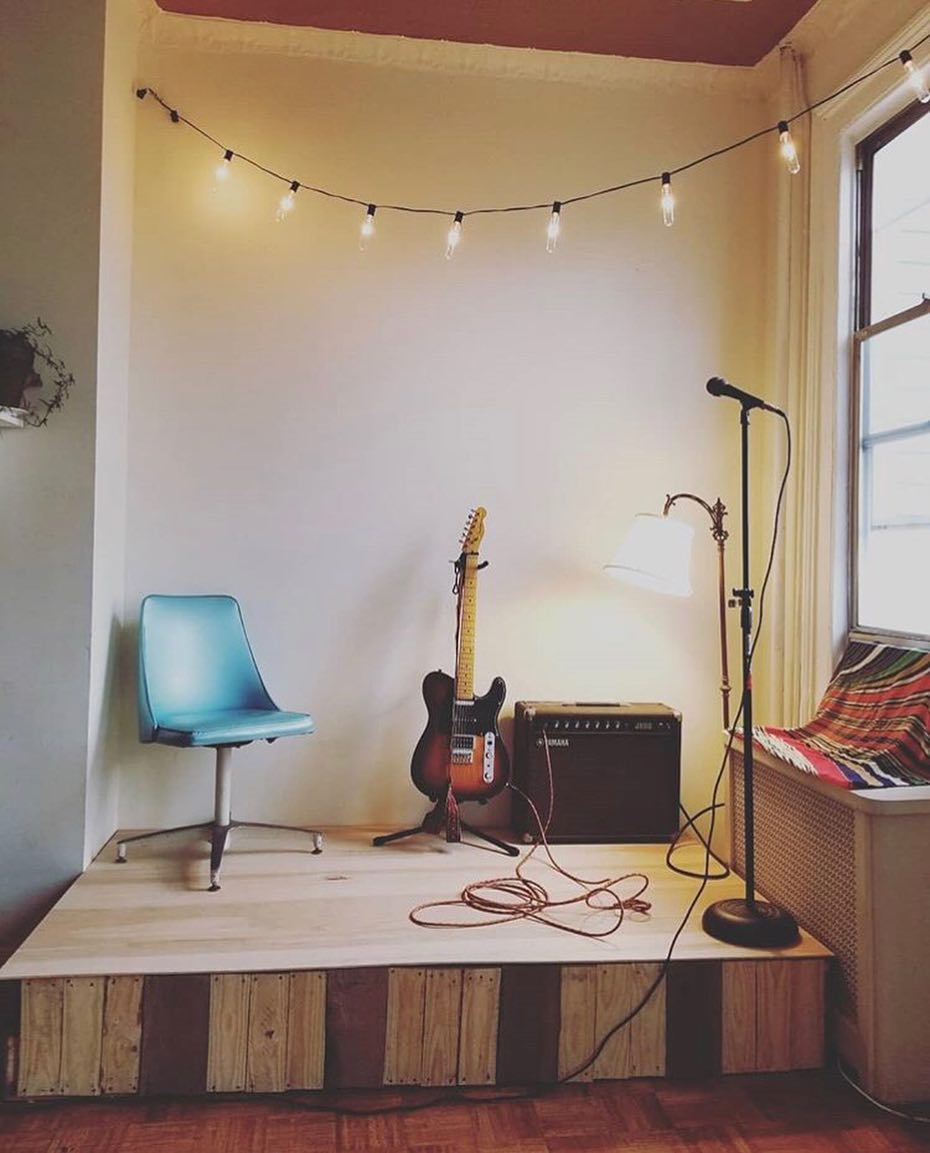 small stage set up with music equipment in home photo by Instagram user @lilomusica