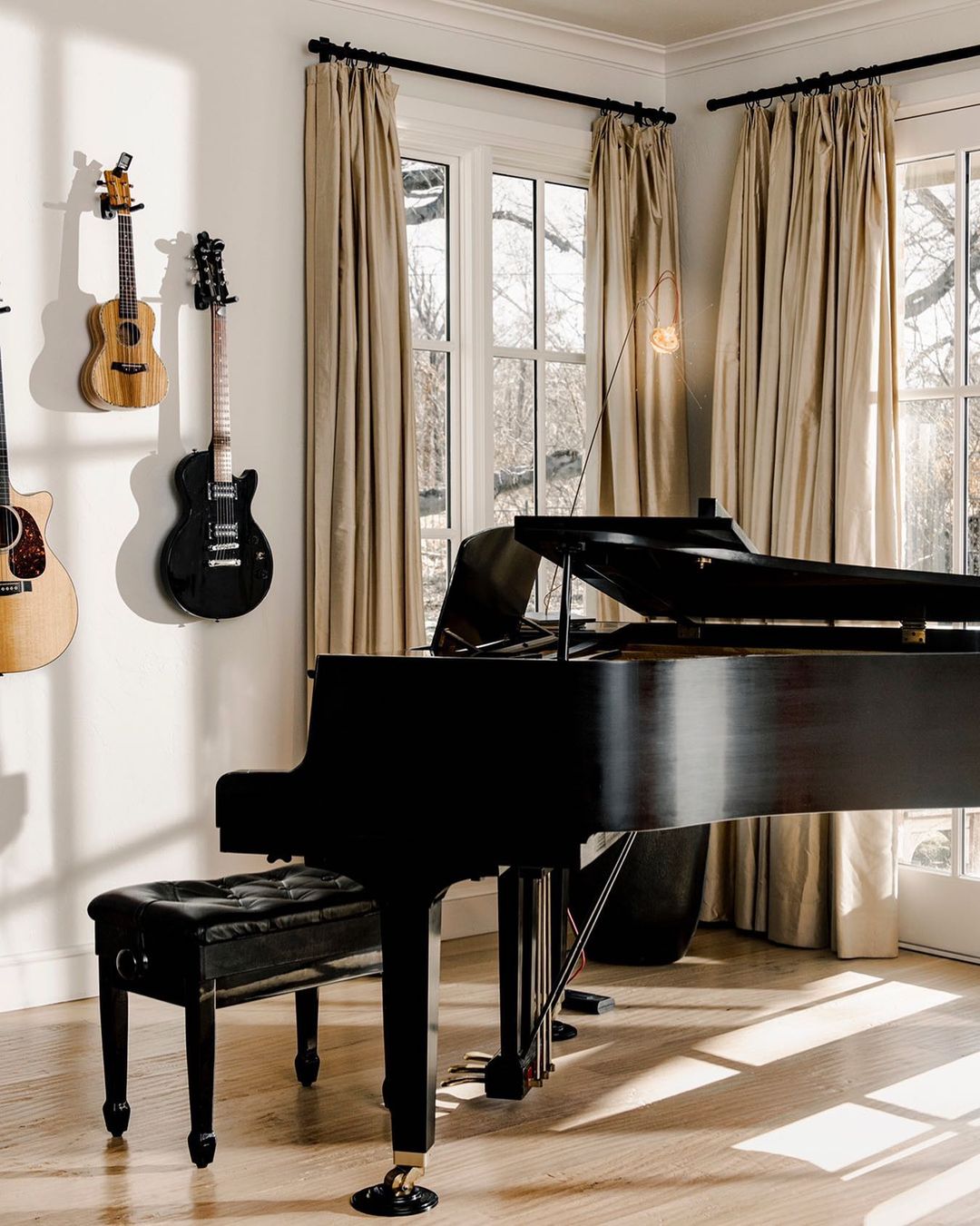 Grand Piano in a Music Room with Guitars on the Wall. Photo by Instagram user @thetonyliproject