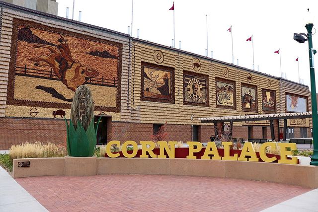 Mitchell Corn Palace exterior and sign with giant ear of corn. Photo by Instagram user @smalltownplussize
