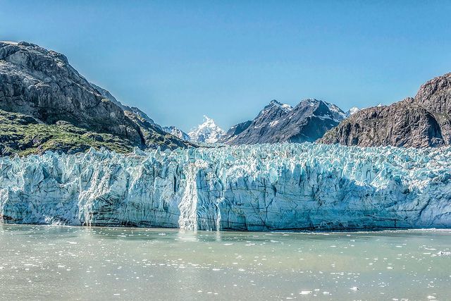 Glacier tinted blue meeting the ocean water. Photo by Instagram user @richardsilverphoto